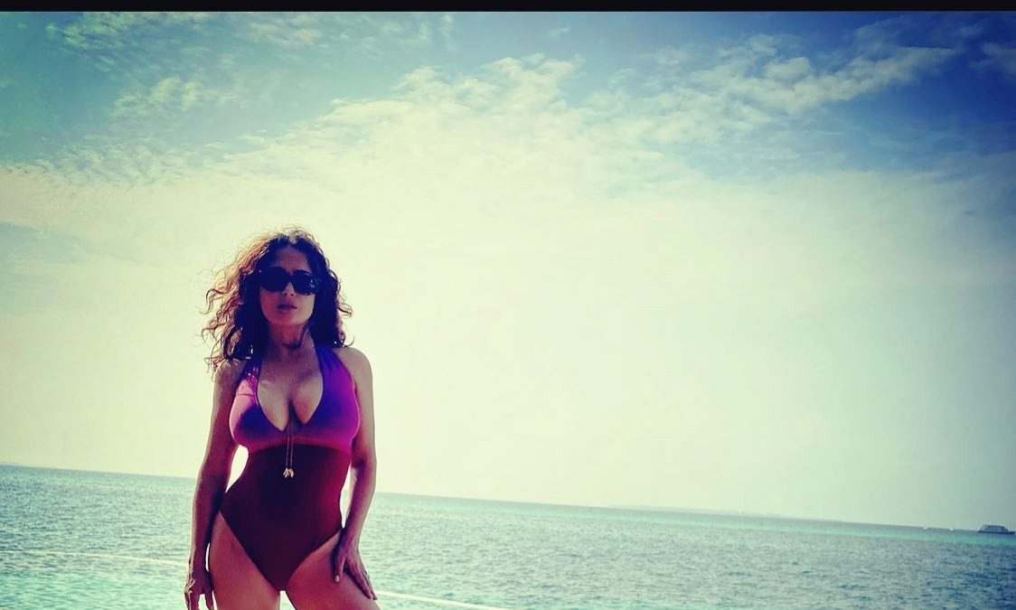 Salma Hayek is showing off her body in swimming suit while resting on a yacht