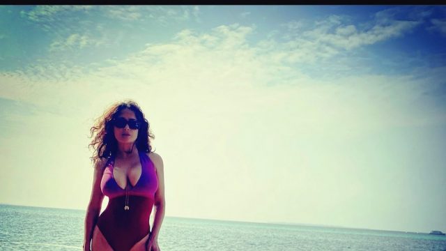 Salma Hayek is showing off her body in swimming suit while resting on a yacht