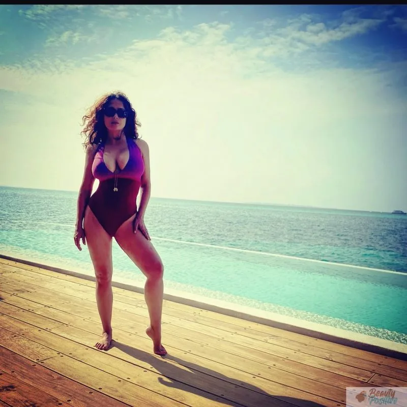 Salma Hayek is showing off her body in swimming suit while resting on a yacht