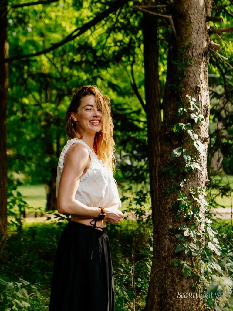Amber Heard in a white blouse among trees, from her Instagram
